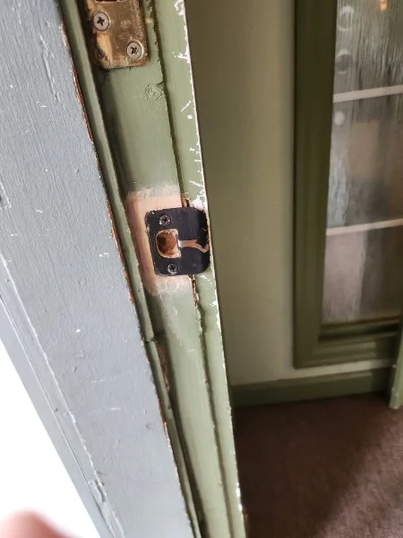 Repaired door strike plate and latch area