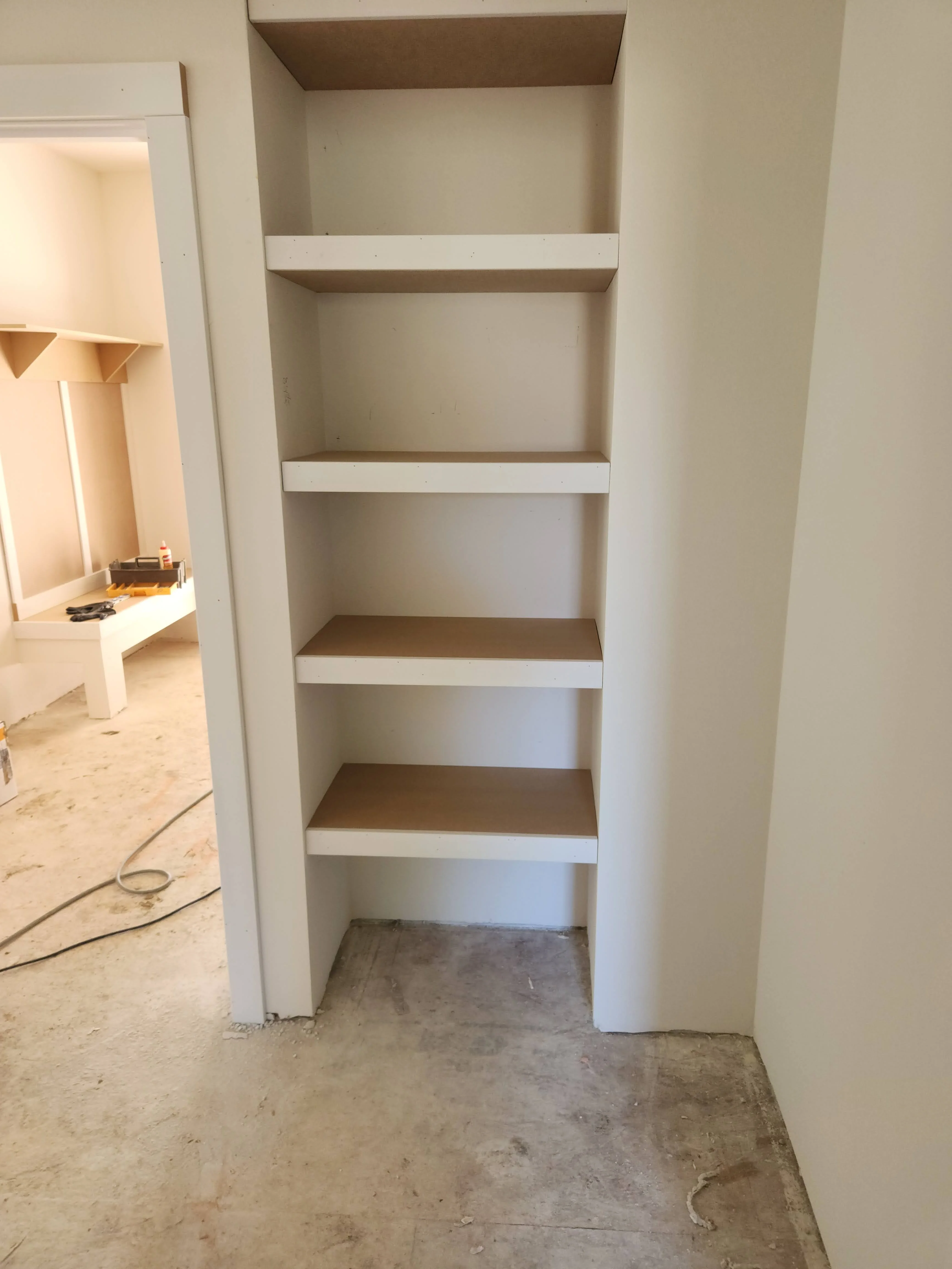 Pantry shelving installed in a recessed opening