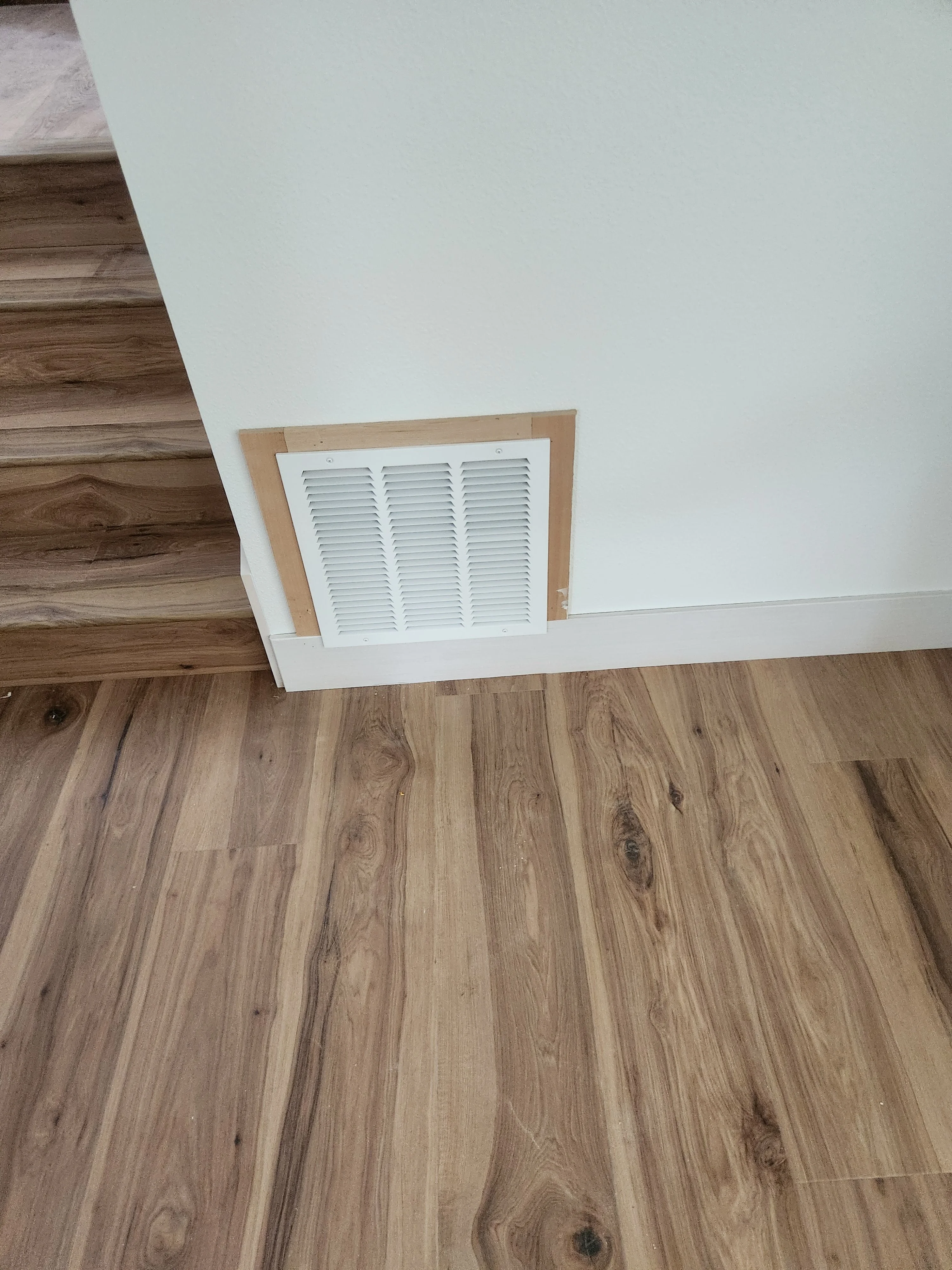 Finished wall vent and base trim detail